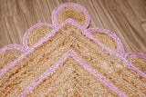 Light pink jute runner edge close-up highlighting scallop stitching