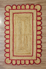 Close-up of scalloped edge detail on red jute runner