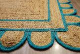 Close-up of scalloped edge detail on teal blue jute runner