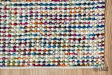 Handwoven multicolour wool rug shown from the corner