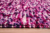 Purple wool rug styled in a living room setting
