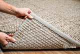 Overhead view of beige chunky wool rug on flooring