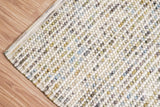 Pastel wool rug shown at an angle in room decor