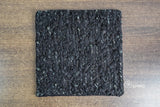 Black wool rug corner detail showing pile