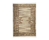 Beige wool kilim rug folded to show flatweave construction