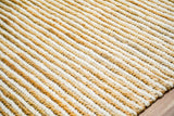 Handwoven wool jute rug placed under a coffee table