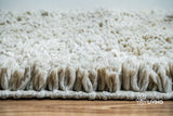 Detail shot of wool fiber texture on taupe grey shag rug