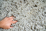 Taupe grey wool shag rug laid flat, full lush texture view
