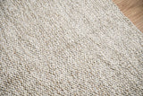 Cashew Loop wool rug — close-up showing the looped wool weave and border