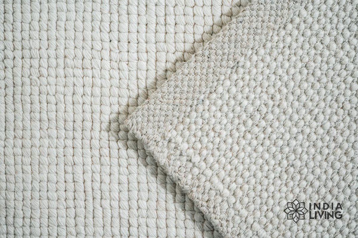 Ivory wool loop weave rug, flat lay view