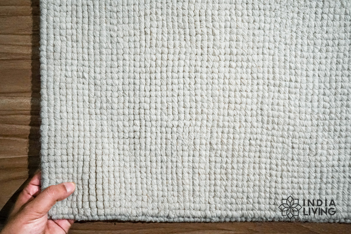 Close-up of ivory wool loop weave texture