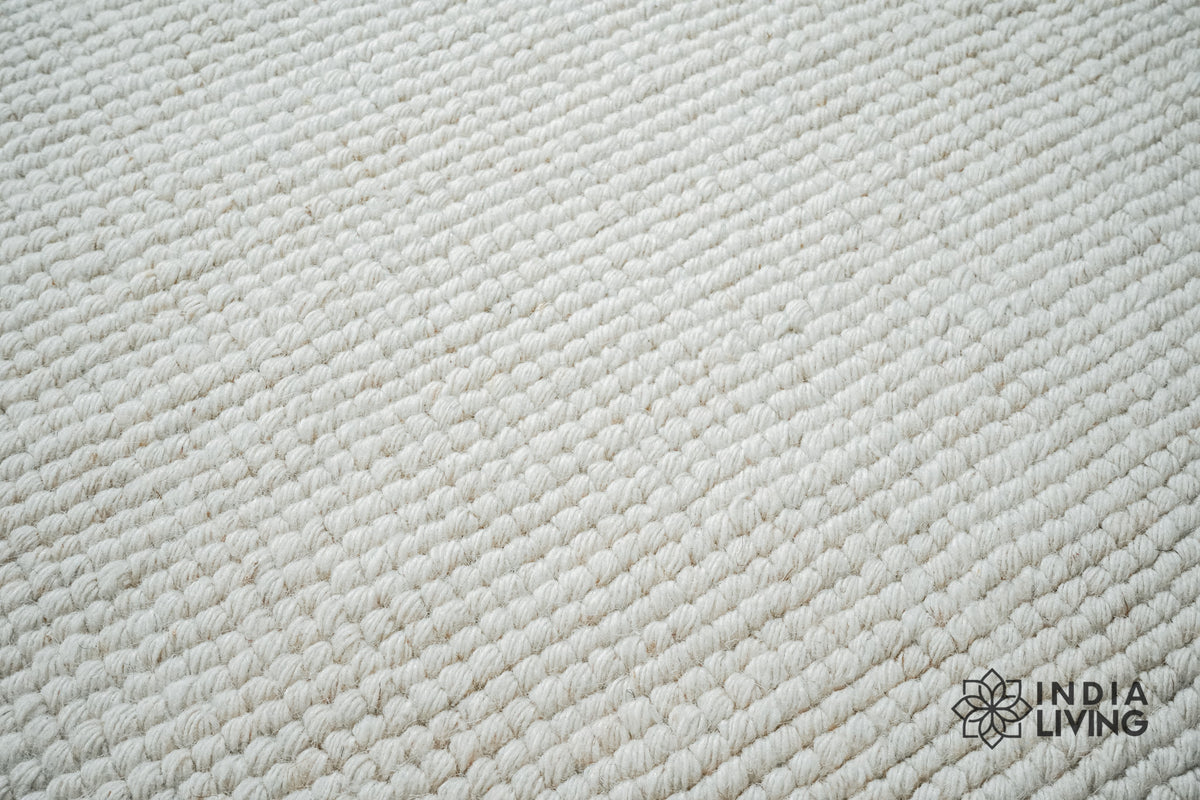 Ivory wool rug shown at full size on wood flooring