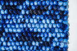 Space dye rug shown at full size on wood flooring