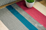 Handwoven wool rug in a boho styled bedroom