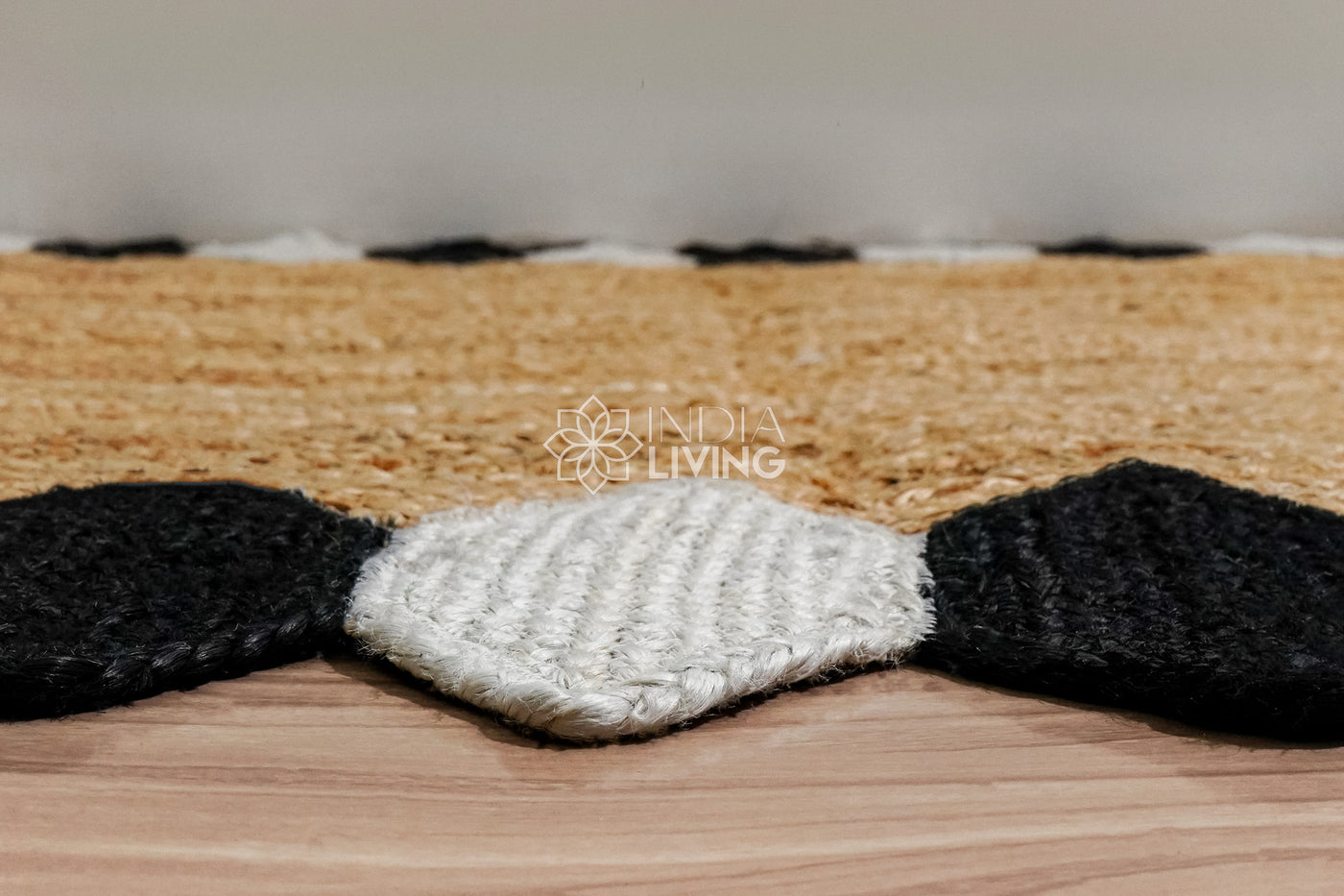Natural jute braided runner rug with black and white border, flat lay