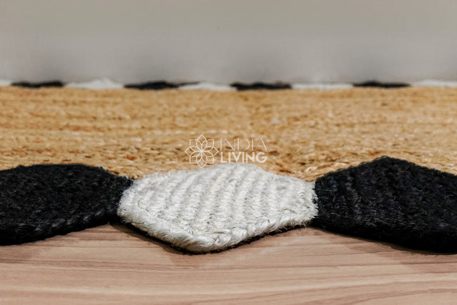 Natural jute braided runner rug with black and white border, flat lay