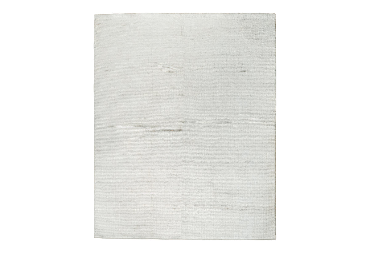 Handwoven ivory wool rug full view on flooring