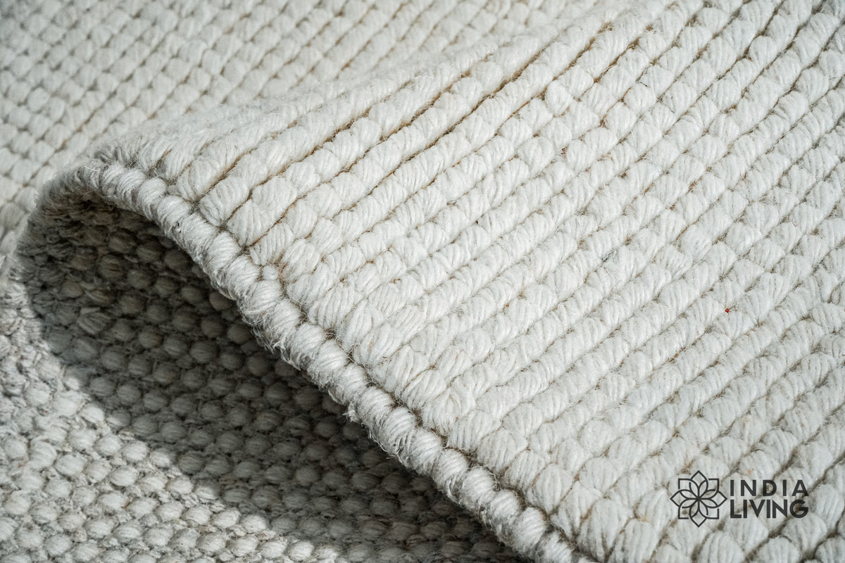 Ivory wool rug styled in a living room