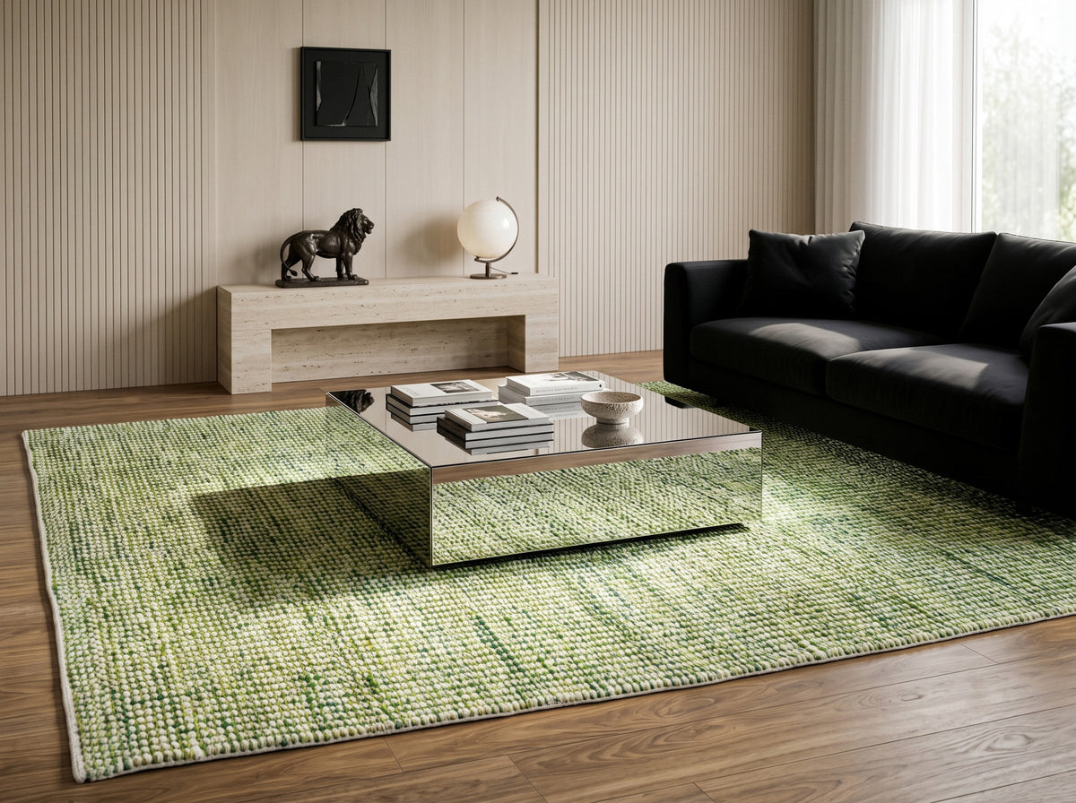 Cashew Loop — green and ivory chunky wool loop rug styled in a living room with a black sofa and mirrored coffee table