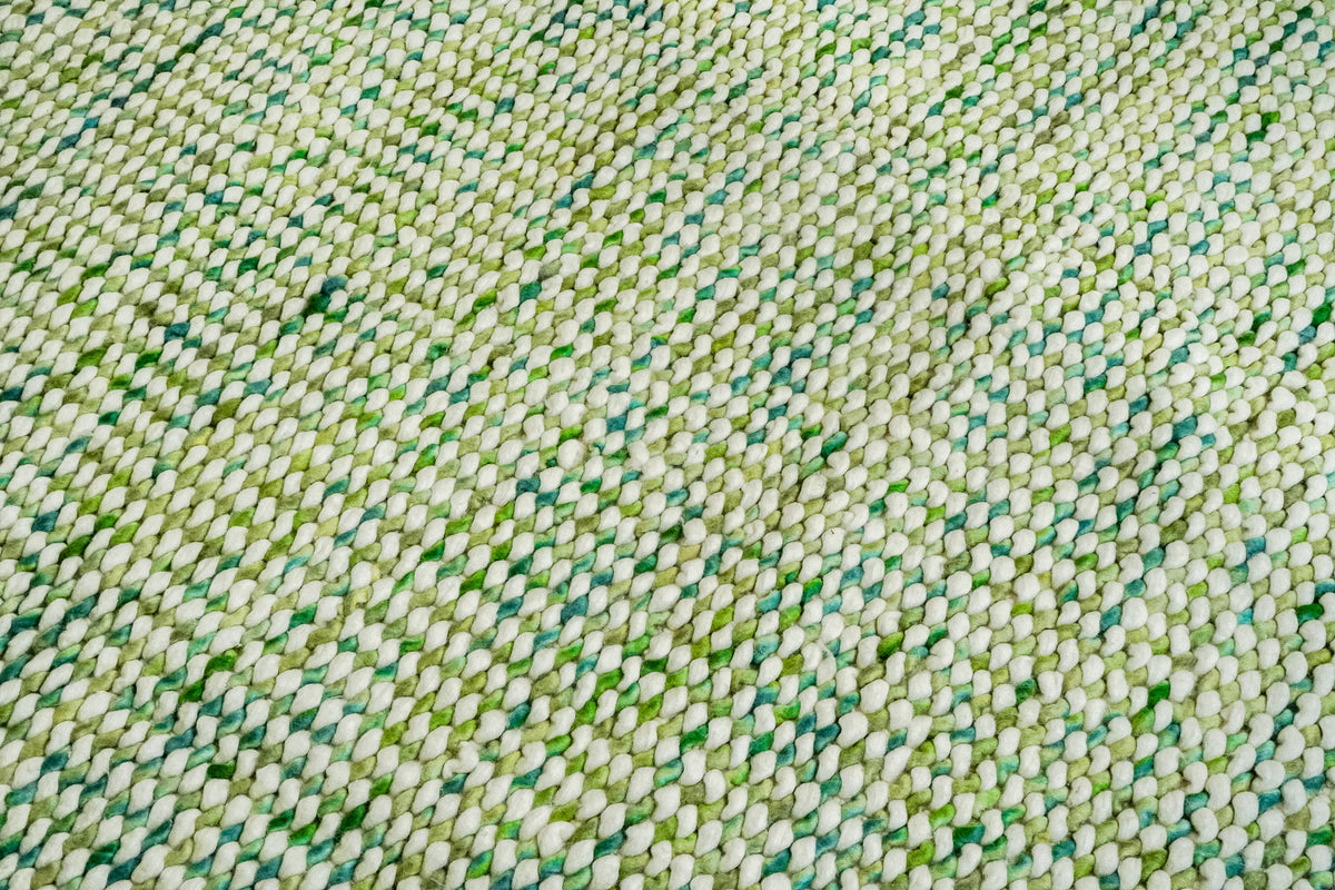 Cashew Loop — chunky wool loop rug with diagonal rows of ivory loops and varied green accents