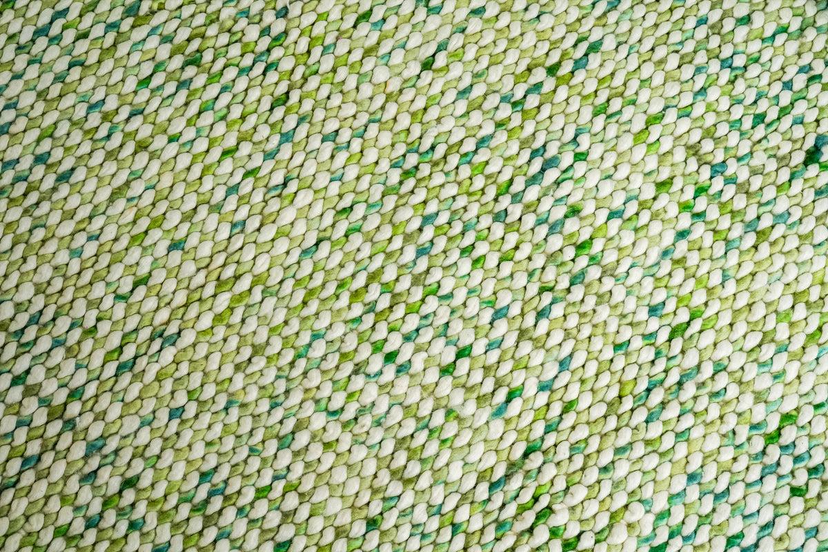 Cashew Loop — broad surface close-up of densely repeated ivory loops interspersed with green