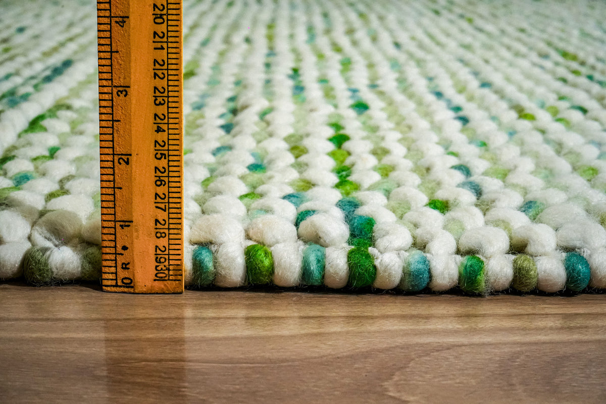 Green Cashew Loop — side view of the wool loop surface with a ruler positioned at the edge