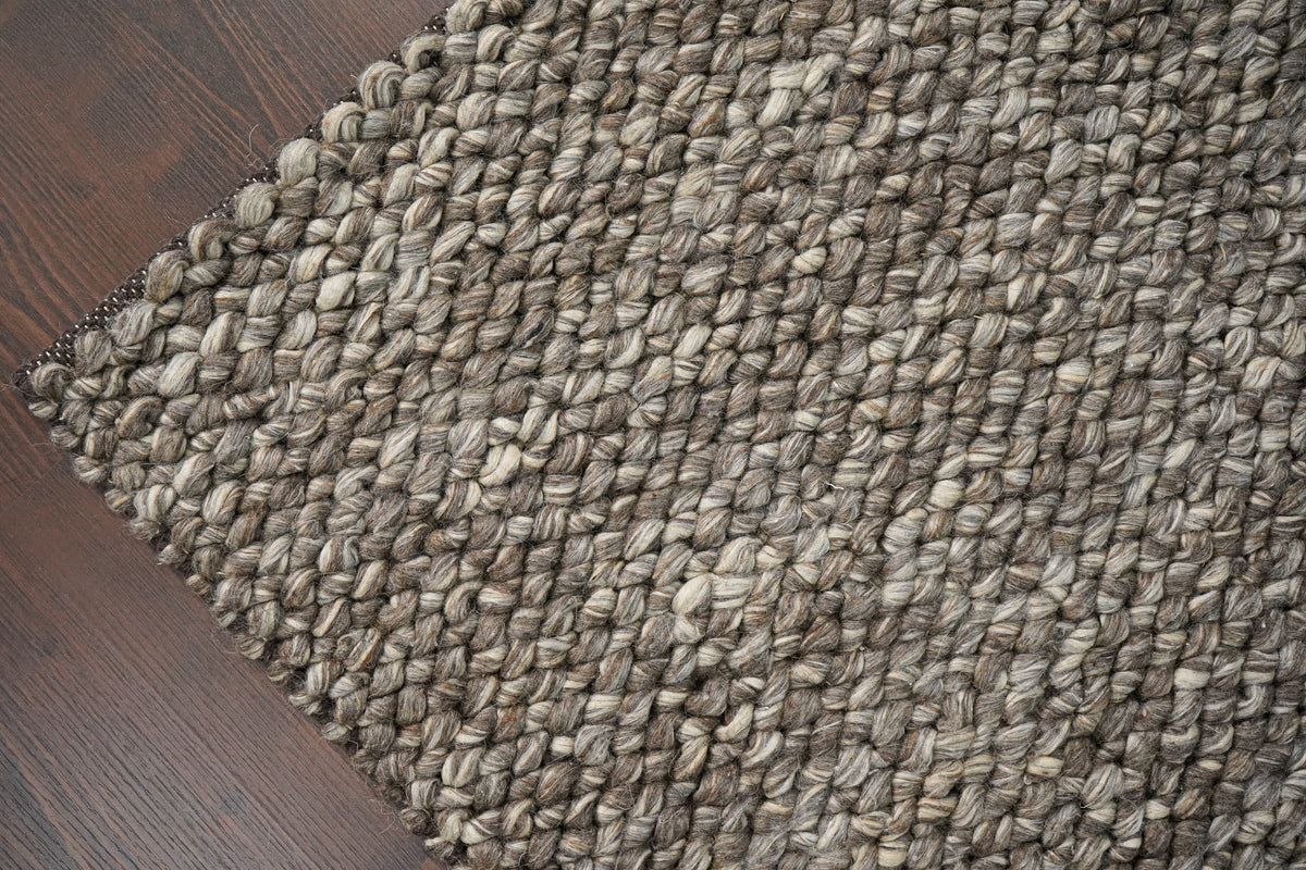Brown Cashew Loops — wool rug with its diagonal edge and closely packed loop pattern in view