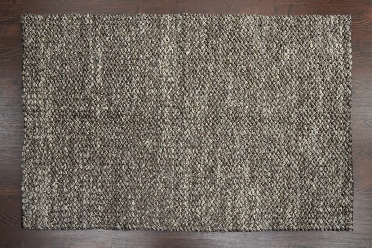 Brown Cashew Loops — wool rug shown fully from above with its rectangular outline on a wooden floor