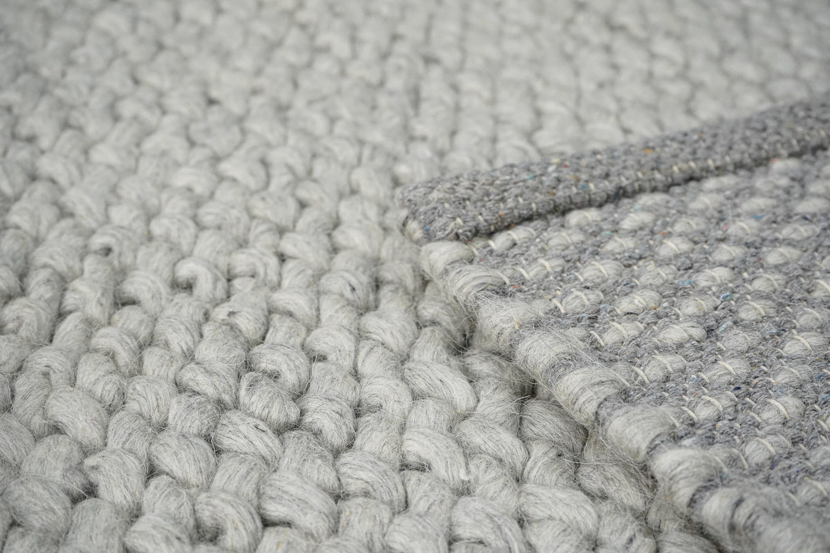 Gray Cashew Loops — wool rug close-up showing surface loops beside the folded underside