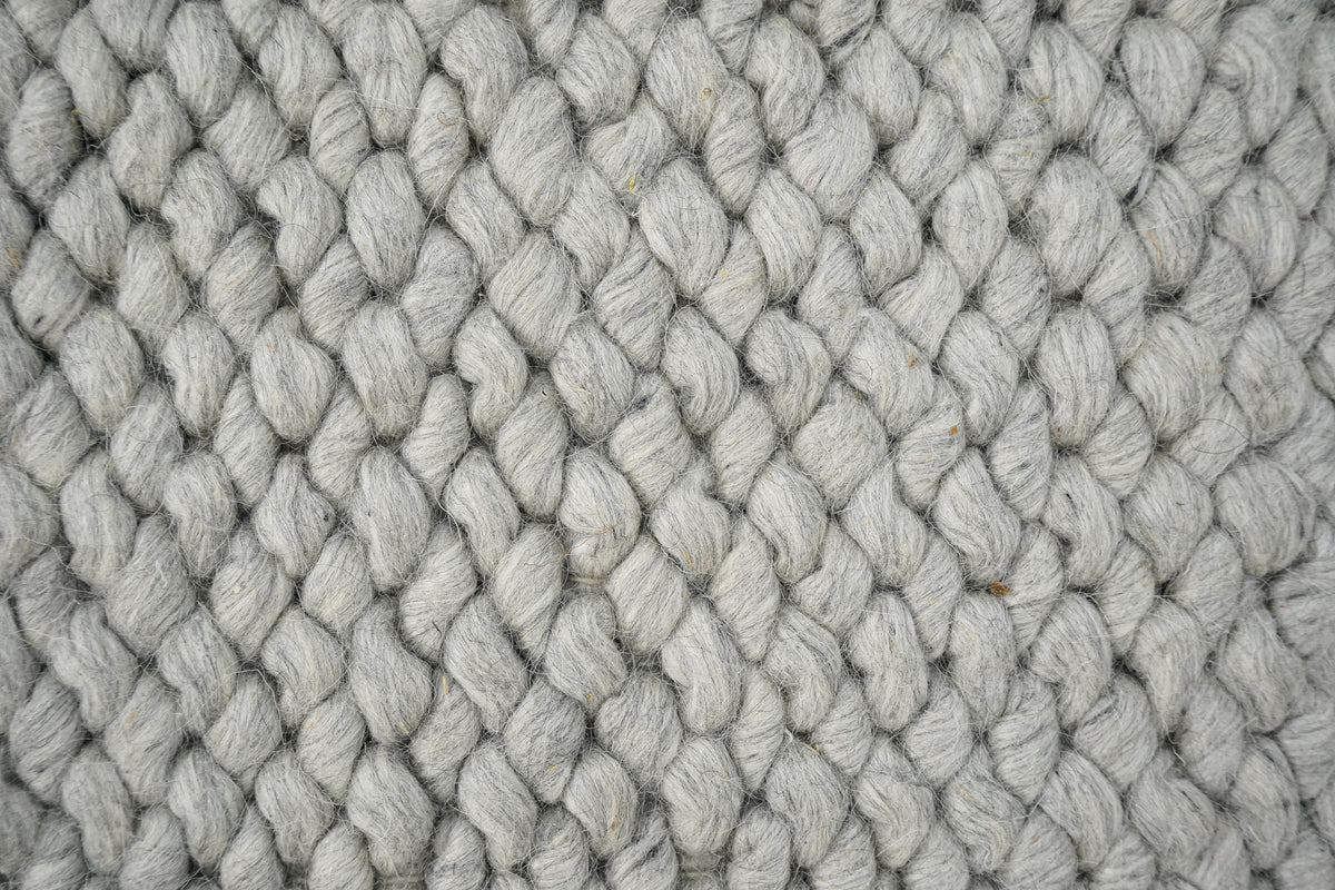 Cashew Loops — wool rug macro view of closely packed gray loops and visible fibers