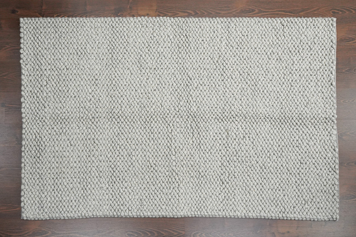 Gray Cashew Loops — wool rug shown fully from above with a rectangular outline on wood flooring