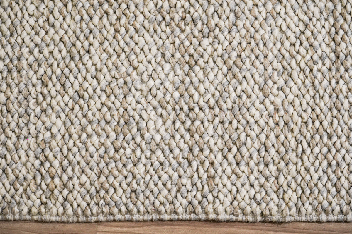 Cashew Loops — wool rug showing rows of ivory, beige and gray loops above a straight finished edge