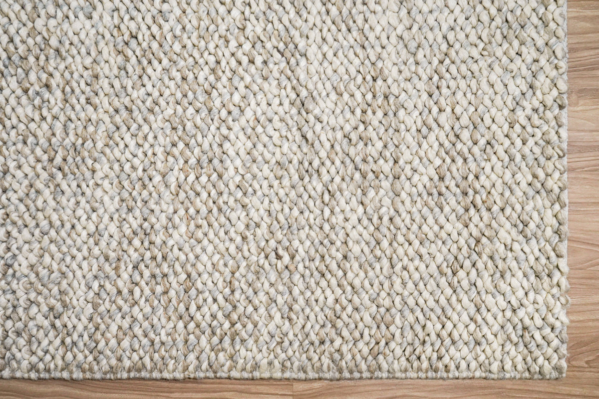 Gray Cashew Loops — wool rug with its lower right corner and two finished edges visible