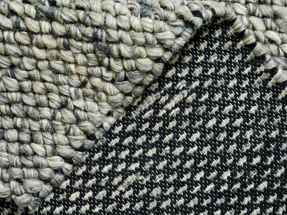 Gray Cashew Loops — Wool rug showing the contrast between the chunky face and dark woven underside