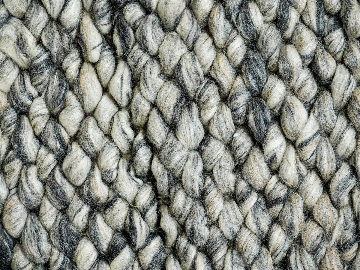 Cashew Loops — Wool rug in a tight detail of elongated loops and intertwined gray strands