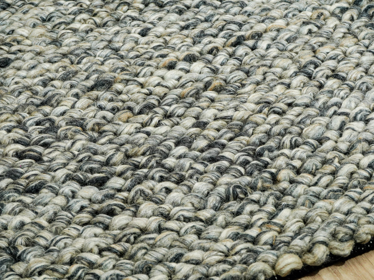 Gray Cashew Loops — Wool rug viewed low across the chunky surface with the near edge in focus