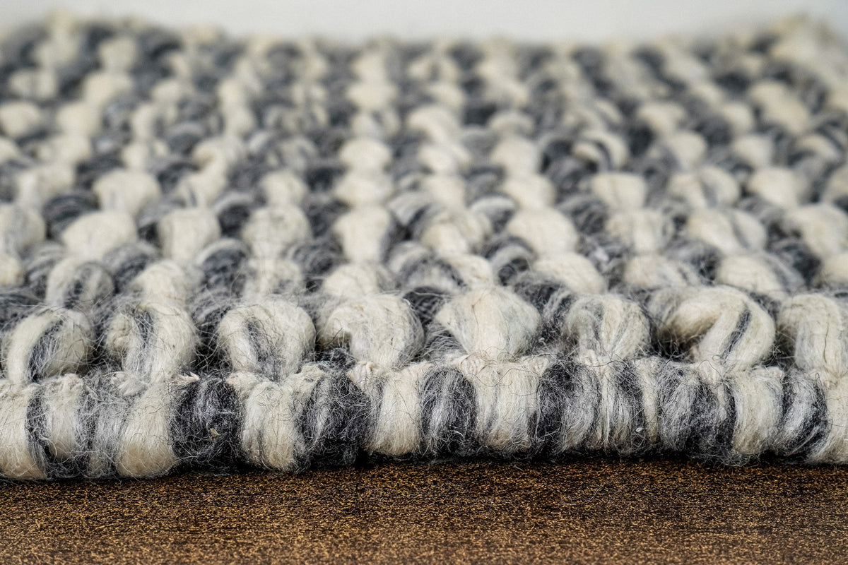 Gray Cashew Loops — Wool rug viewed at surface level, showing raised loops along the front edge