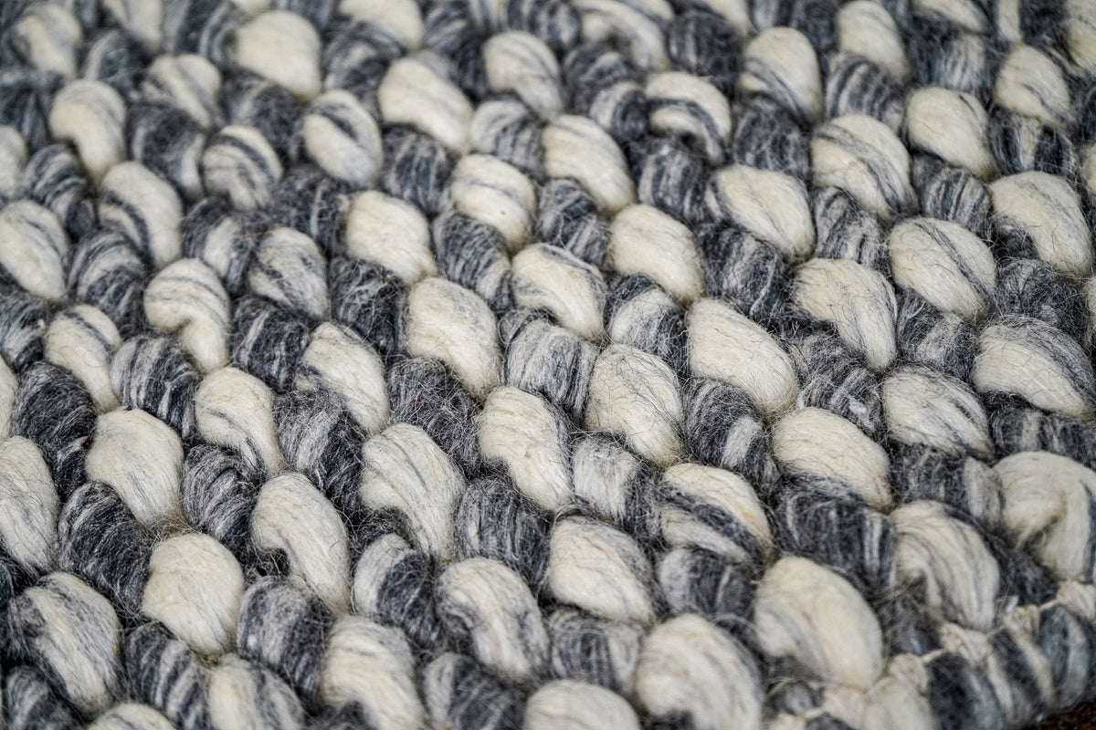 Gray Cashew Loops — Wool rug close-up showing repeating rounded loops and contrasting yarn tones