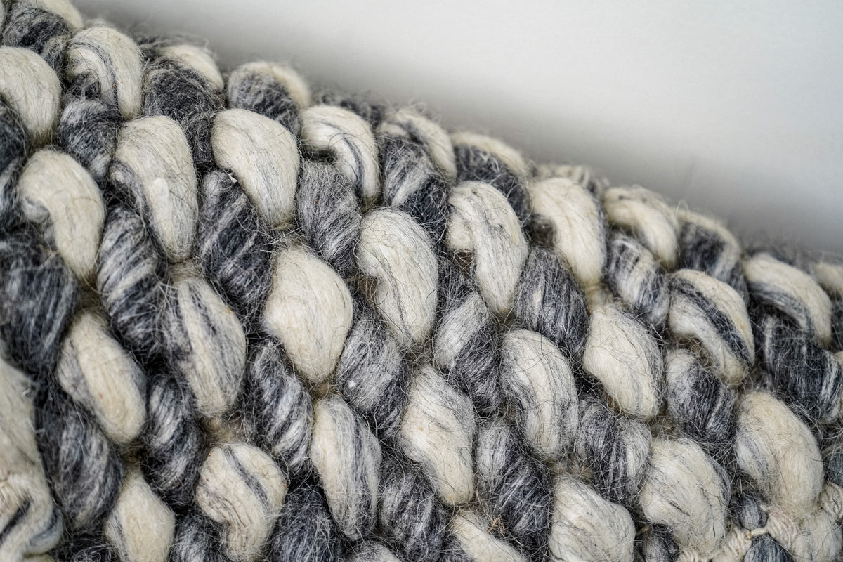 Gray Cashew Loops — Wool rug angled texture detail showing individual fibers around the loops