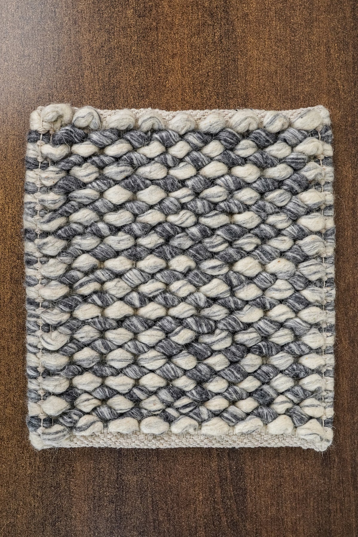 Gray Cashew Loops — Wool rug sample viewed from above, showing its complete outline and edge finish