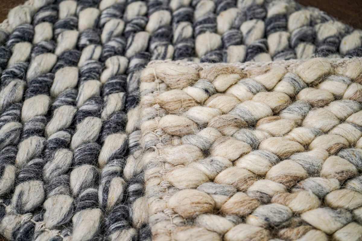 Cashew Loops — Wool rug partial close-up of dark gray and pale loop rows on the left