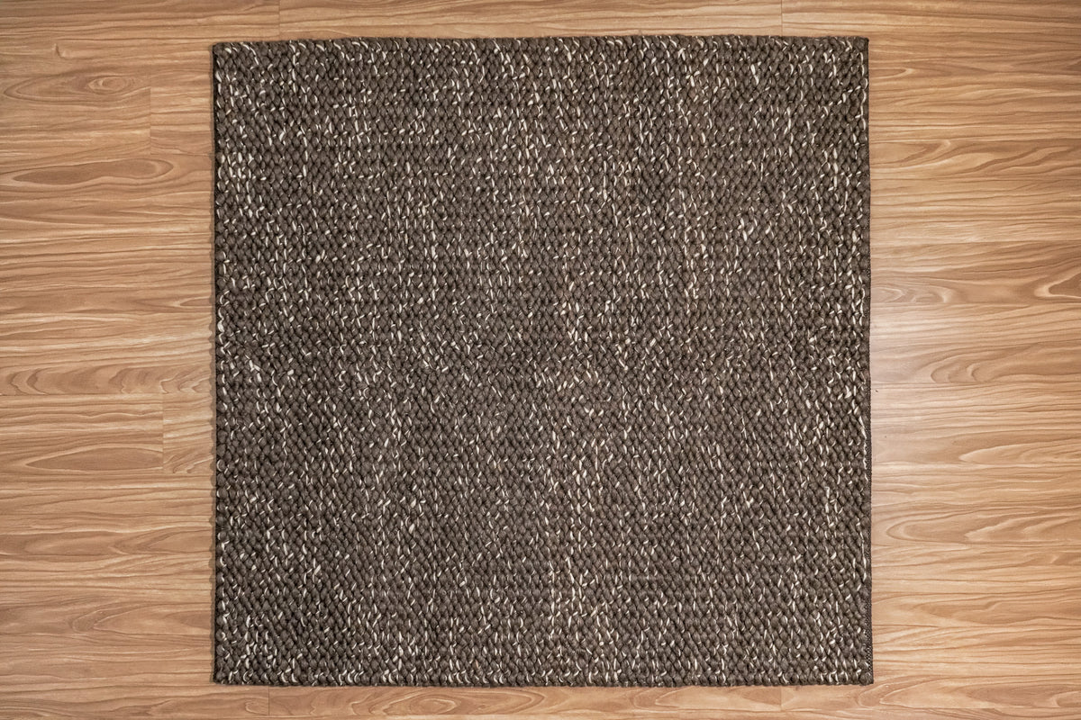 Cashew Loops — full overhead view of the brown wool rug with ivory flecks on a wood floor