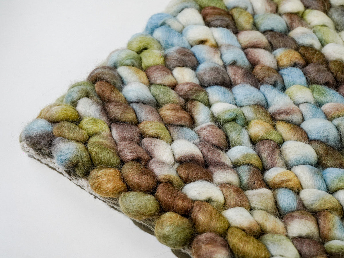 Multicolor Cashew Loop — Wool rug with an angled corner showing rounded loops and the finished edge