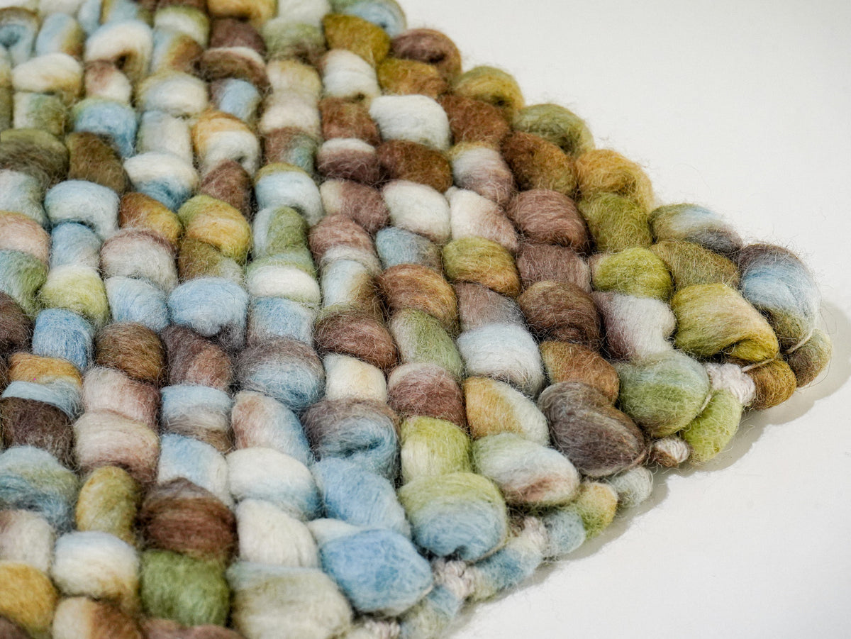 Multicolor Cashew Loop — Wool rug corner detail with rounded loops along two adjoining edges