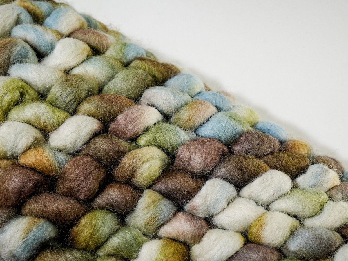 Multicolor Cashew Loop — Wool rug angled surface detail with cream and brown loops in the foreground