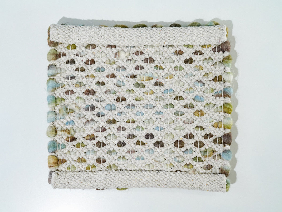 Multicolor Cashew Loop — Wool rug full underside view with cream woven bands at opposite ends