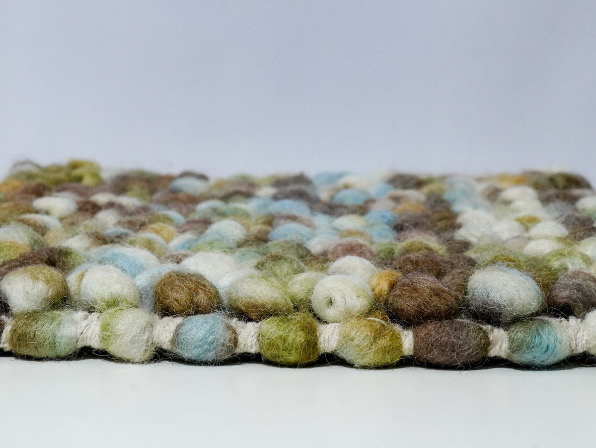 Multicolor Cashew Loop — Wool rug side profile showing the raised loop surface above the base