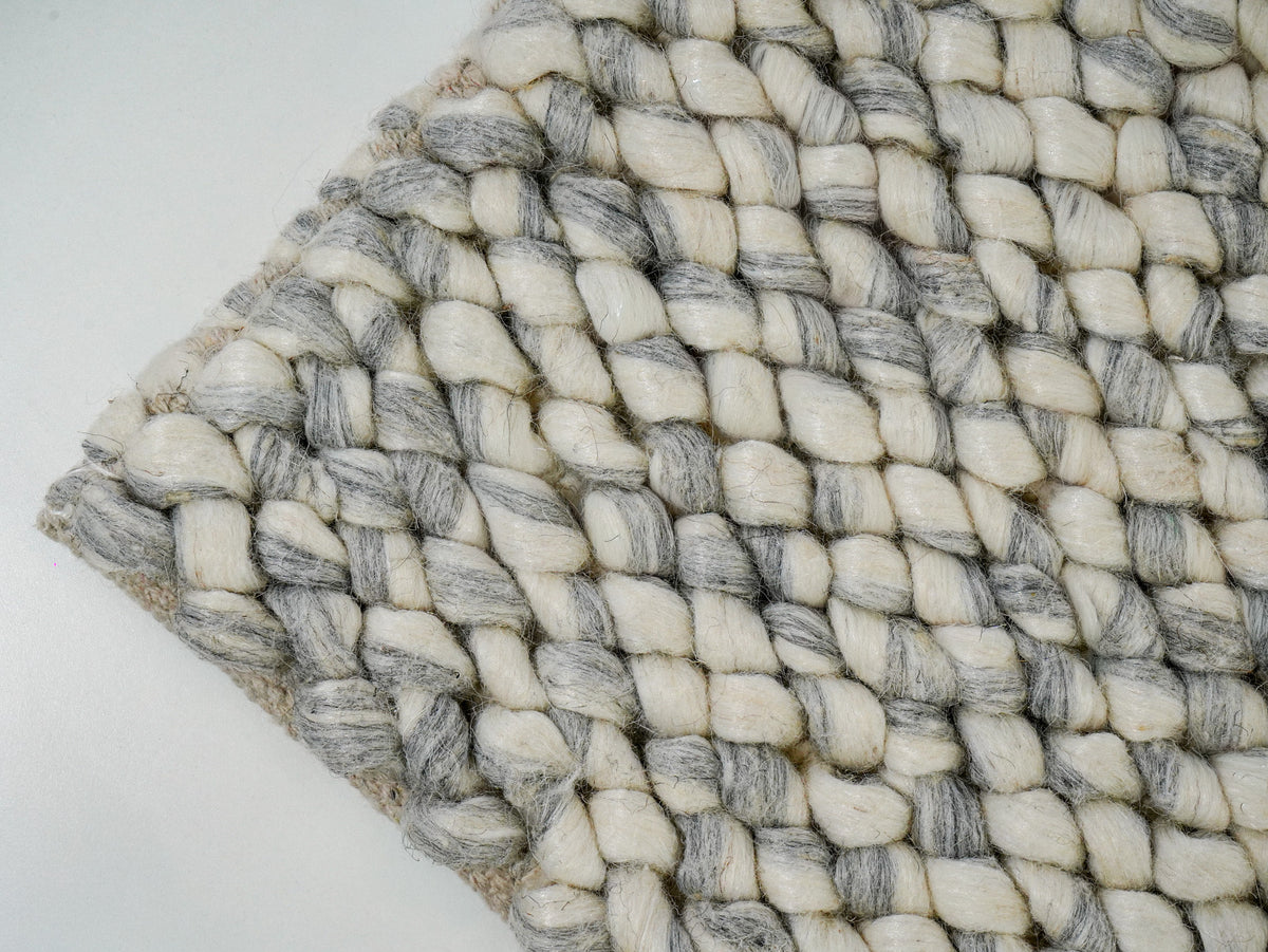 Cashew Loop — Wool rug with a diagonal corner view of ivory and gray loops