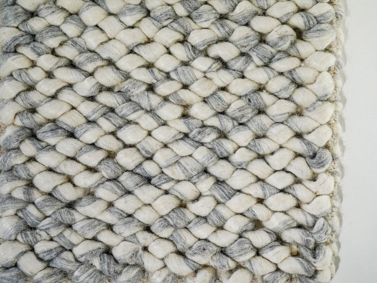 Gray Cashew Loop — Wool rug showing closely spaced loops beside the right edge