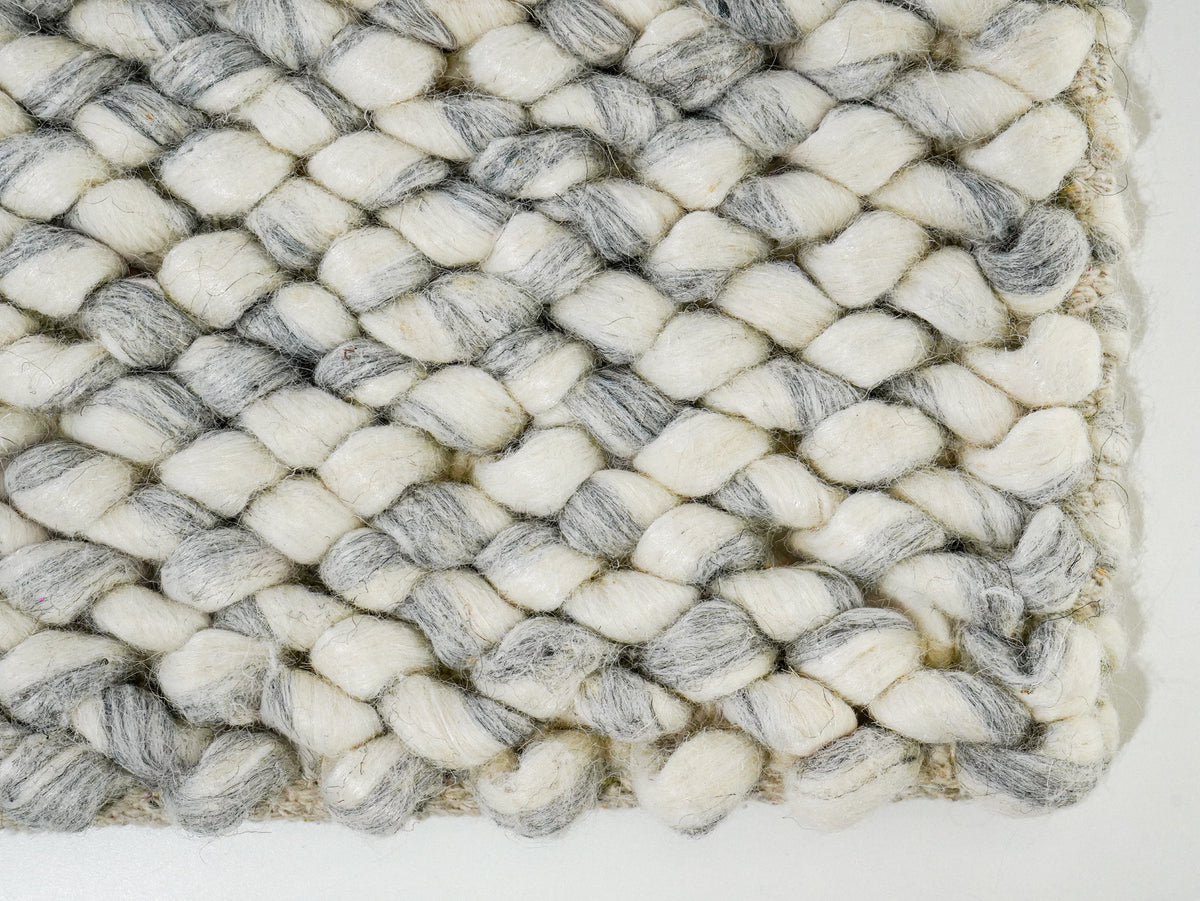 Gray Cashew Loop — Wool rug with a close view of the lower-right corner and rounded loops